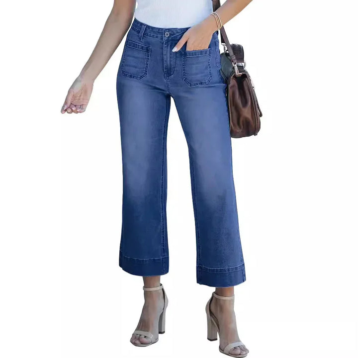 Women's cropped blue denim jeans with front patch pockets, paired with beige block heel sandals