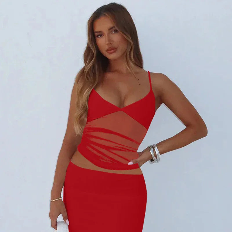 Woman wearing a stylish red cutout dress with spaghetti straps posing against a plain light background