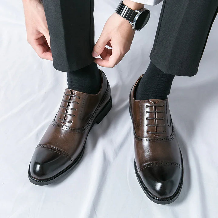 Man wearing black socks and brown leather dress shoes with cap toes and brogue details