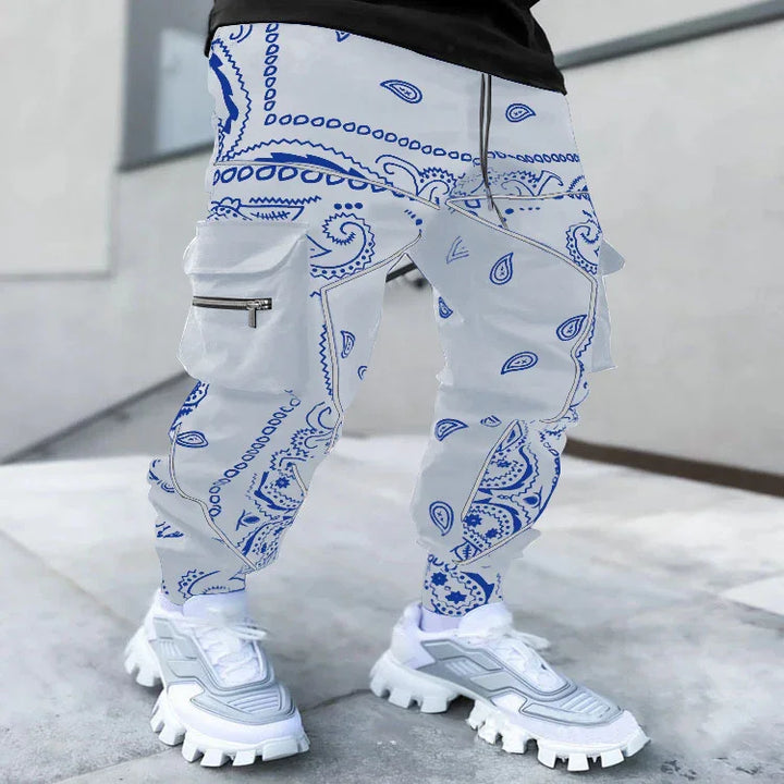 White cargo pants with blue paisley bandana print worn with chunky white sneakers on urban sidewalk
