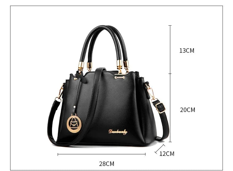 Black leather handbag with gold accents, top handles, shoulder strap, and size dimensions