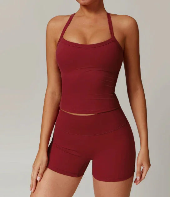 woman wearing maroon fitted tank top and high-waisted biker shorts activewear set