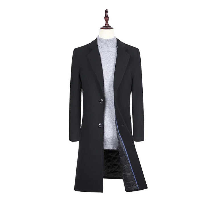 Men's black tailored overcoat with button closure over grey turtleneck sweater on mannequin