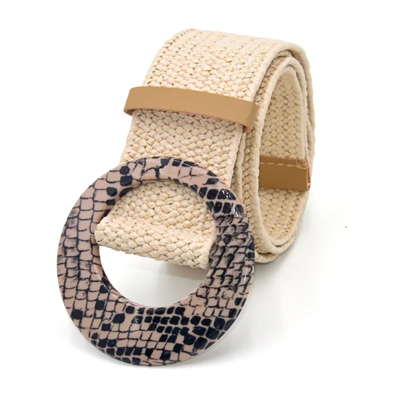 Beige woven belt with large round snakeskin-patterned buckle on white background