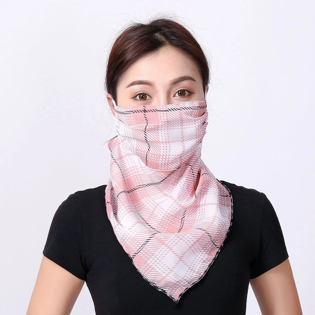 Woman wearing pink and white checkered face covering bandana and black t-shirt on white background