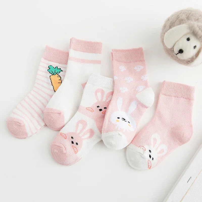 Set of five pastel pink and white baby socks with bunny faces, carrot, and polka dot patterns