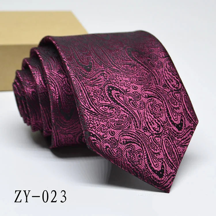 Purple paisley patterned men's necktie rolled up on white surface with code ZY-023