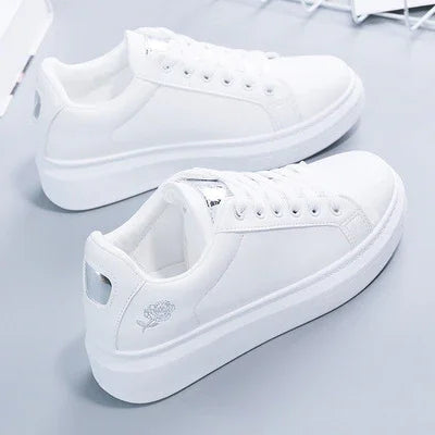 White casual platform sneakers with lace-up design and subtle rose embroidery on heel