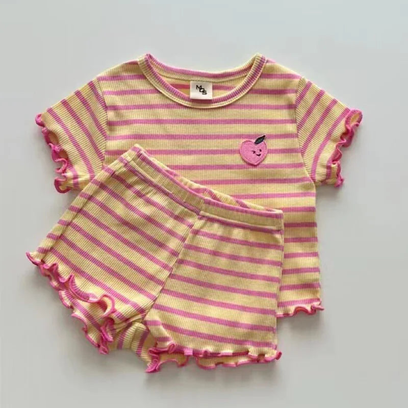 Yellow and pink striped toddler outfit with ruffled edges and embroidered peach patch on shirt