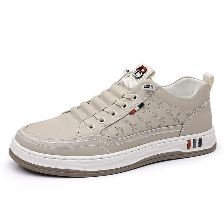 Beige casual sneaker with textured pattern, lace-up design, and white sole featuring red and blue accents