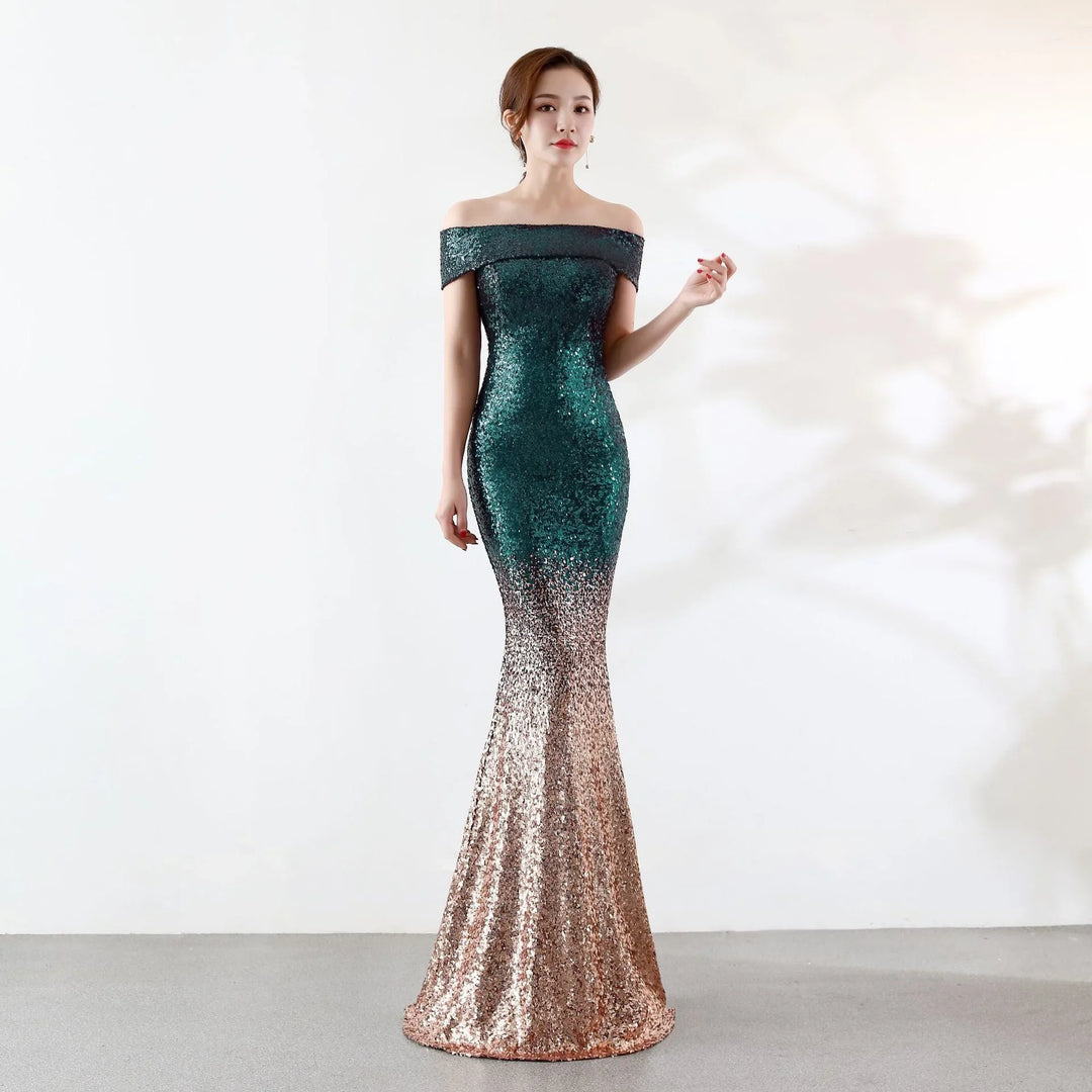 Woman wearing a sequined off-shoulder mermaid gown in green and gold gradient on plain background