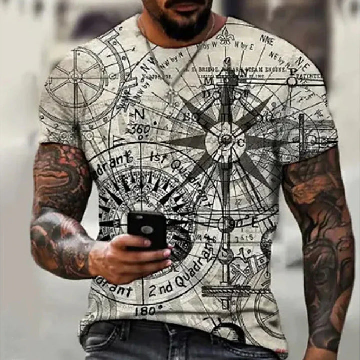 Man wearing a white t-shirt with black nautical compass design and map prints, holding a smartphone