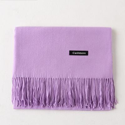 Folded lavender cashmere scarf with fringed edges on white background