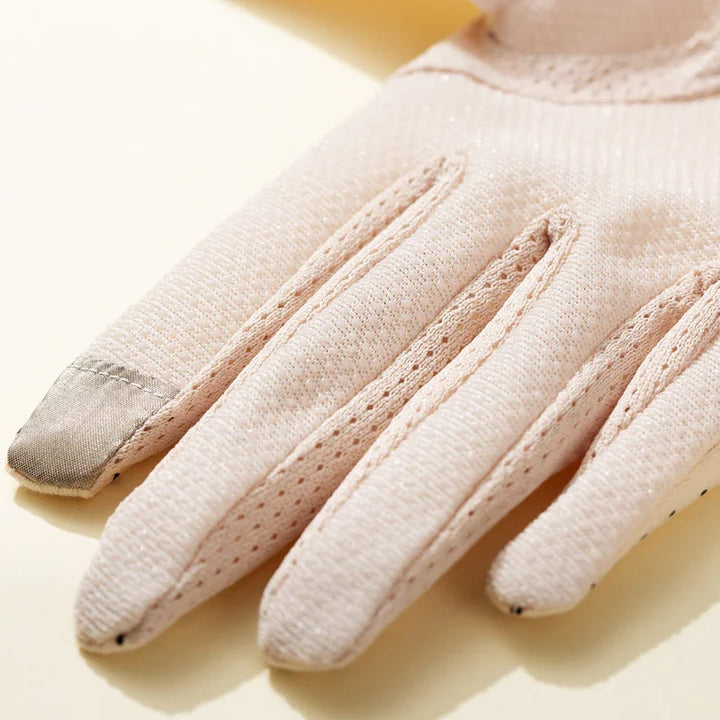 Close-up of light pink breathable fabric glove with reinforced fingertip and textured stitching
