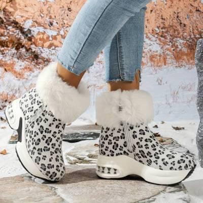 White leopard print winter ankle boots with fur trim worn with blue jeans on stone floor