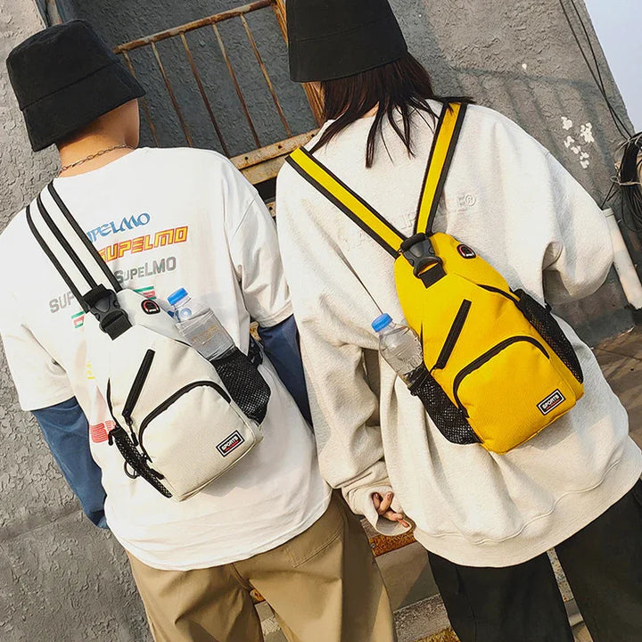 Two people wearing black hats and casual clothes with white and yellow sporty sling backpacks holding water bottles