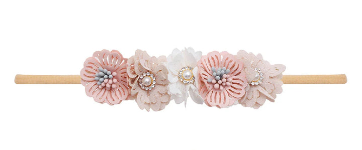 Delicate flower headband with pink and white fabric flowers embellished with pearls and rhinestones on beige band