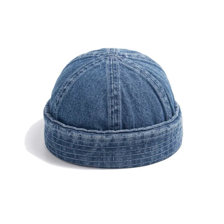 blue denim docker cap with stitched panels and folded brim on white background
