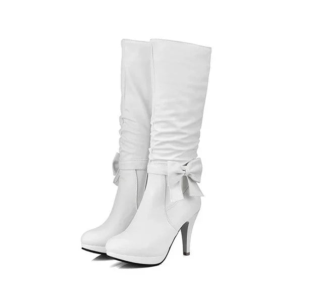 White high-heeled women's boots with ruched shaft and bow detail on side, elegant fashion footwear