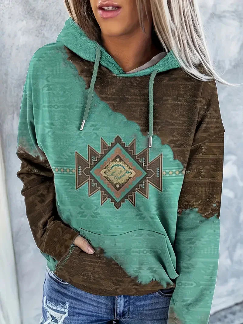 Woman wearing teal and brown hoodie with geometric tribal pattern and front pocket