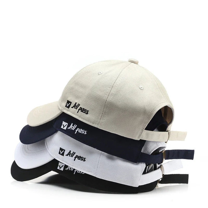 Stack of adjustable baseball caps in beige, navy, white, and black with 'All pass' embroidered