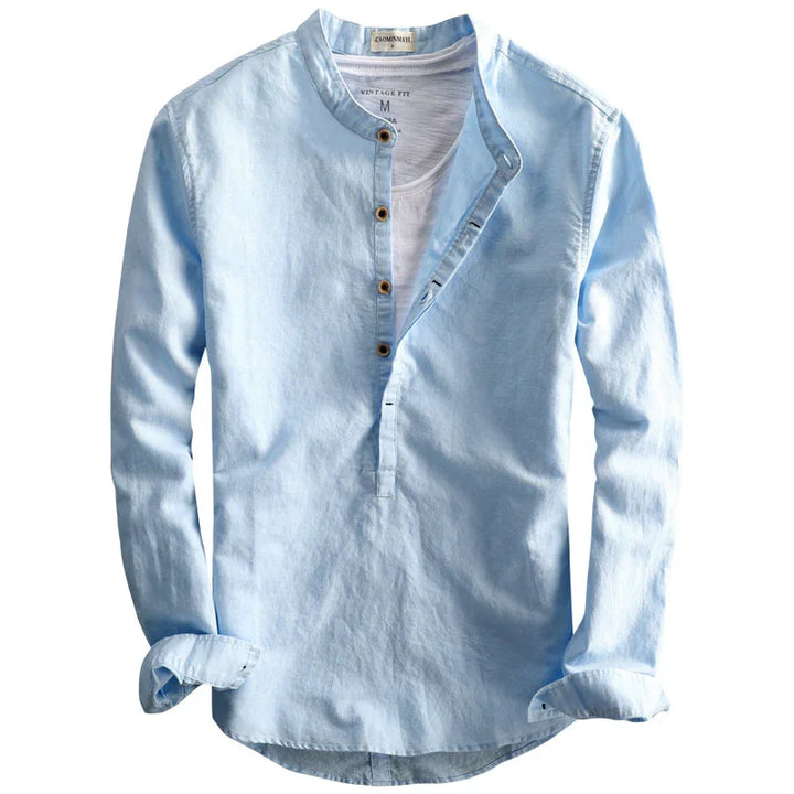 Light blue vintage fit long sleeve shirt with Mandarin collar and button placket over white undershirt