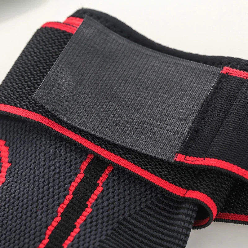 Black and red elastic wrist support brace with adjustable Velcro strap, close-up view