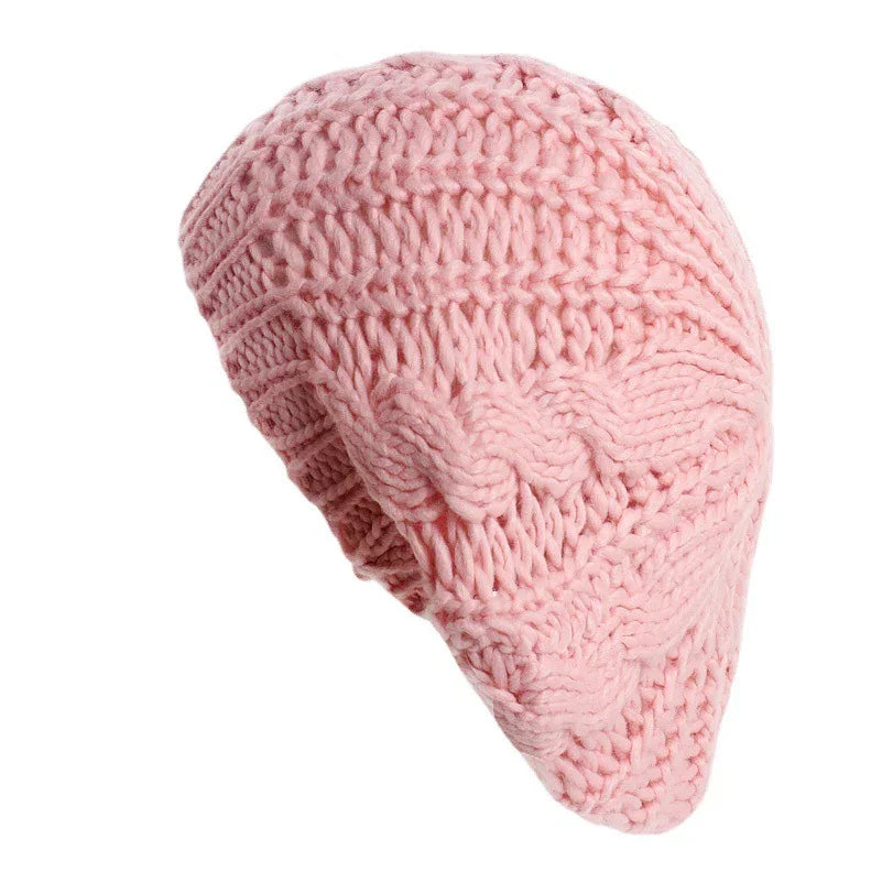Soft pink knitted woolen beanie hat with cable and ribbed stitch patterns
