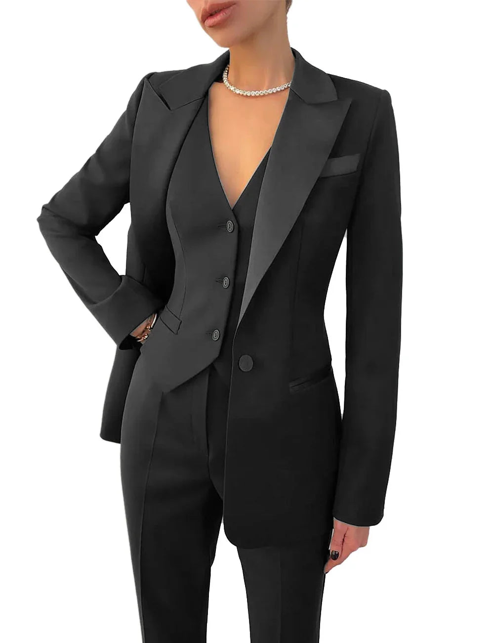 Woman wearing stylish black tailored suit with blazer, vest, trousers, and pearl necklace