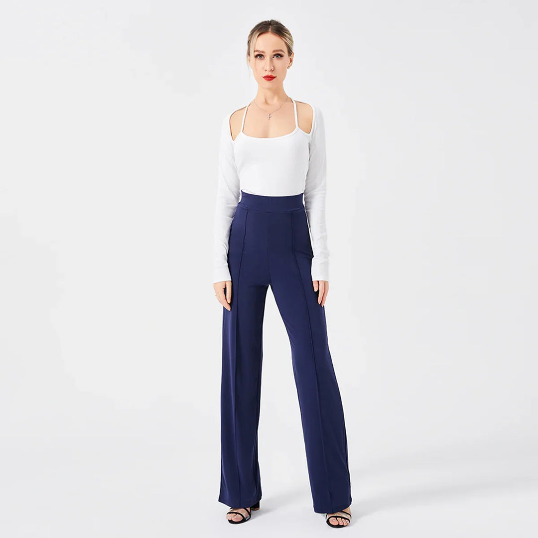 Woman wearing white cold shoulder top and high waist navy blue wide-leg pants on white background
