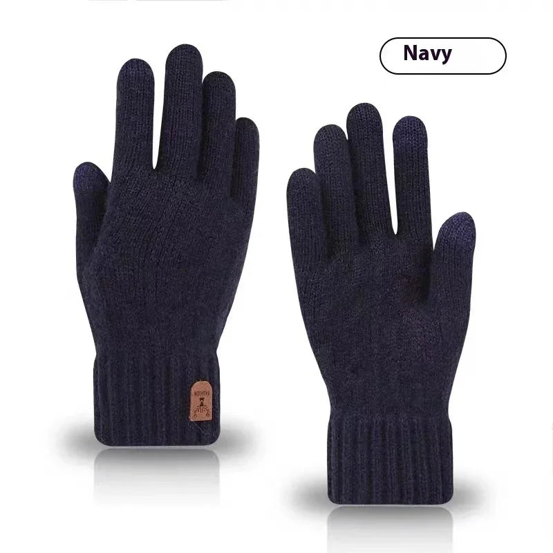 Pair of navy blue knit winter gloves with ribbed cuffs and small leather label on white background