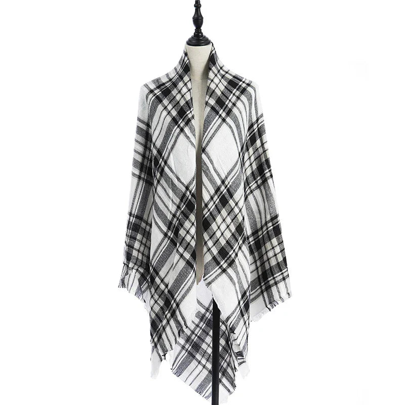 Black and white plaid shawl wrap displayed on mannequin with fringed edges