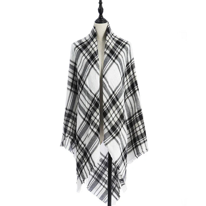 Black and white plaid shawl wrap displayed on mannequin with fringed edges