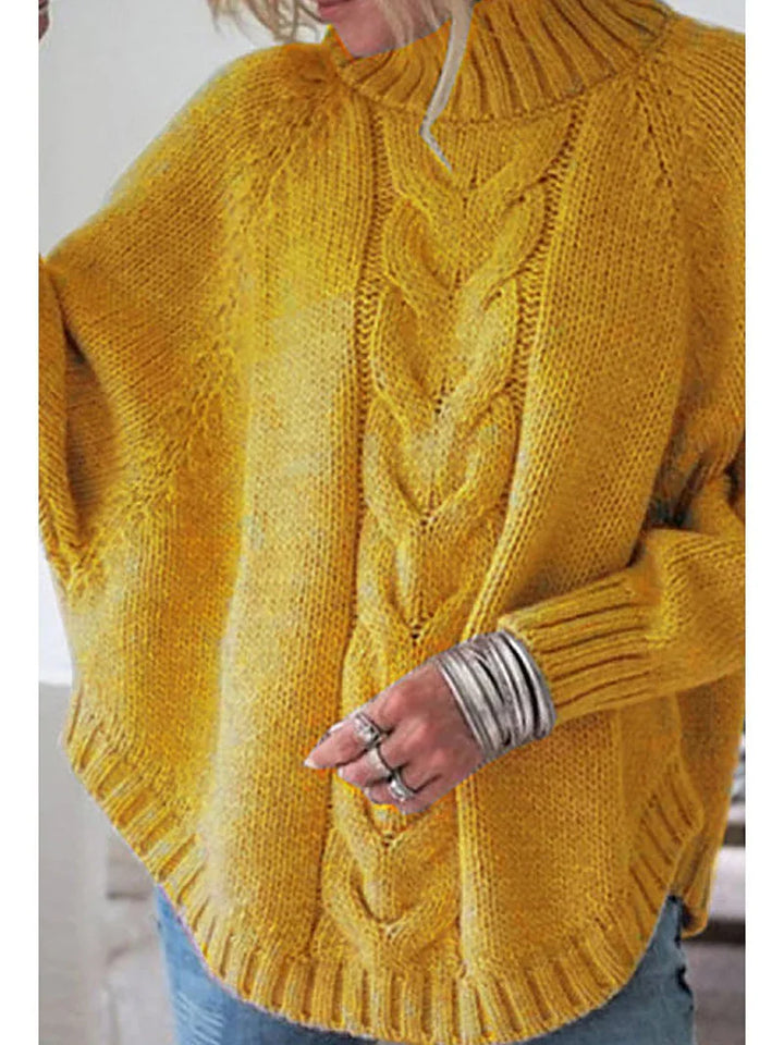 Cozy mustard yellow knitted sweater with cable pattern and ribbed edges worn with silver rings and bracelets