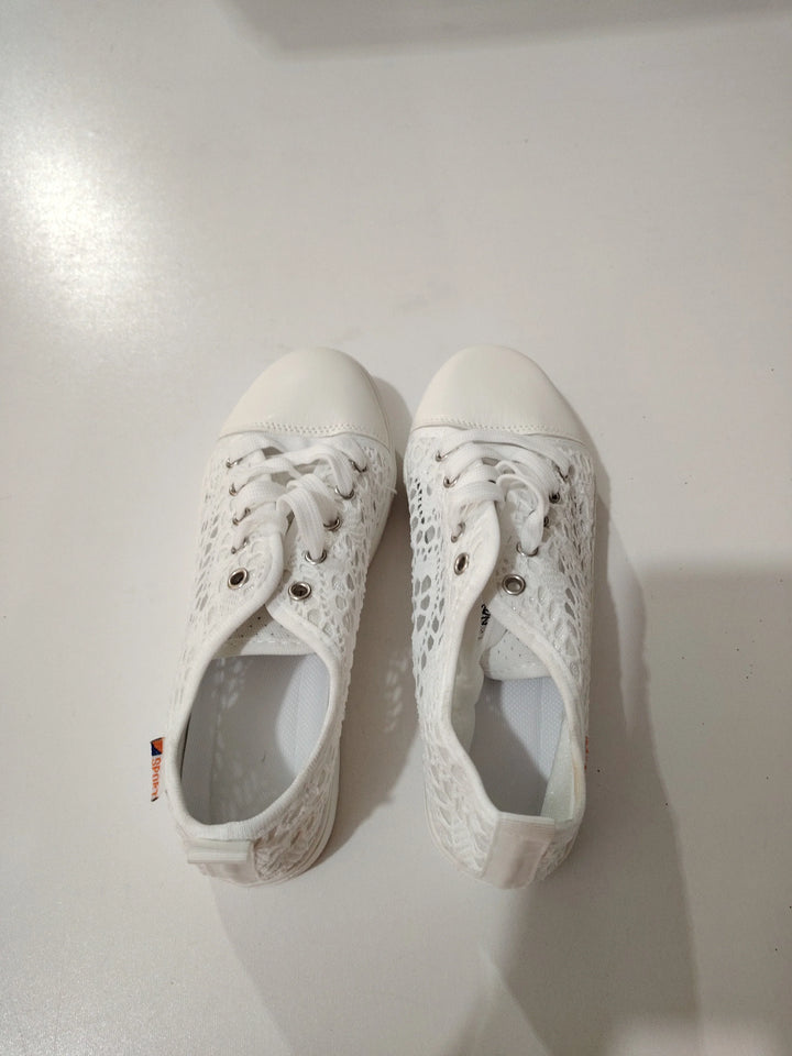 Pair of white lace sneakers with rubber toe caps and white laces on white surface