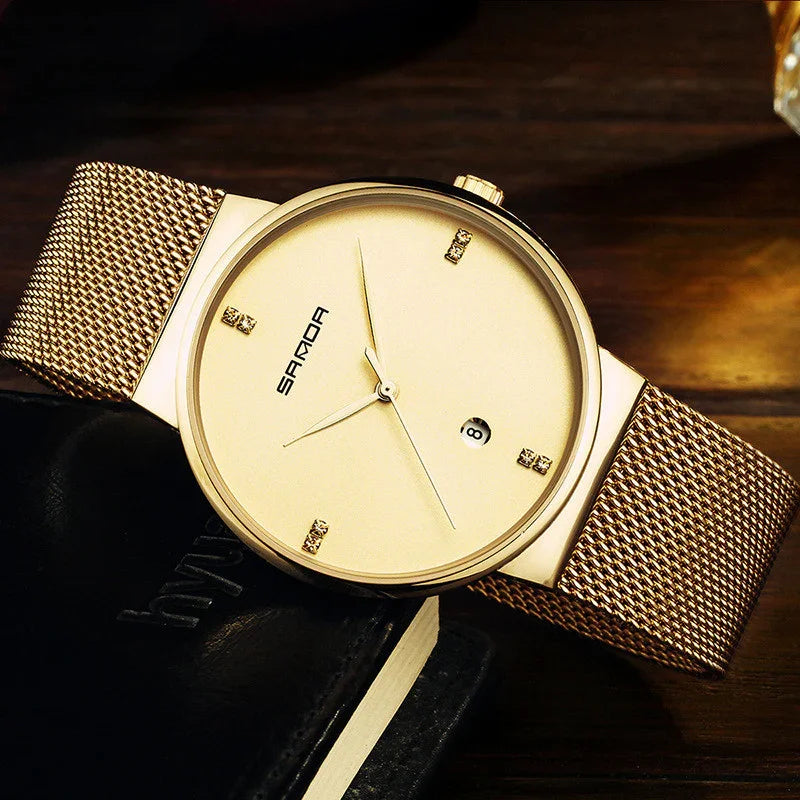 Elegant gold Sanda wristwatch with mesh band, minimalist dial, and date window on wooden surface