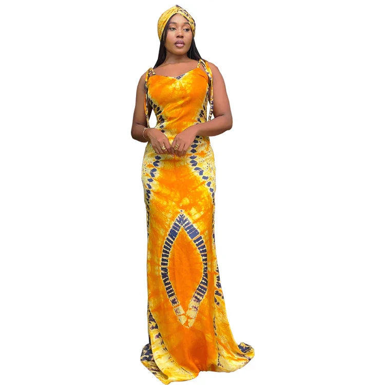Woman wearing a vibrant orange and yellow tie-dye maxi dress with matching headwrap