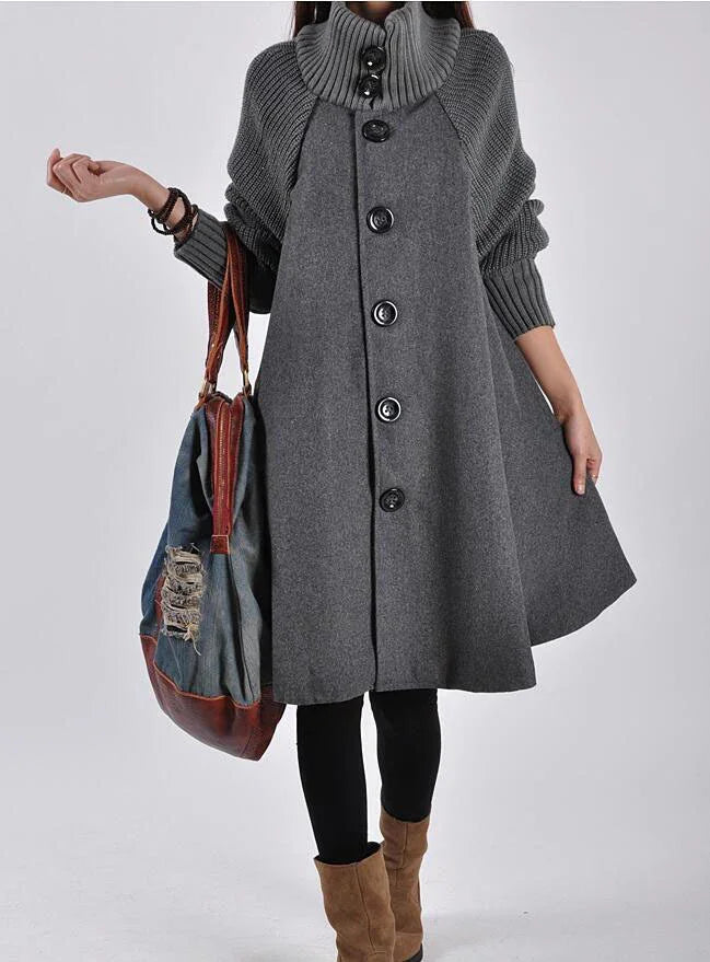 Woman wearing a grey oversized buttoned wool coat with ribbed sleeves and collar, carrying a distressed denim and leather tote bag