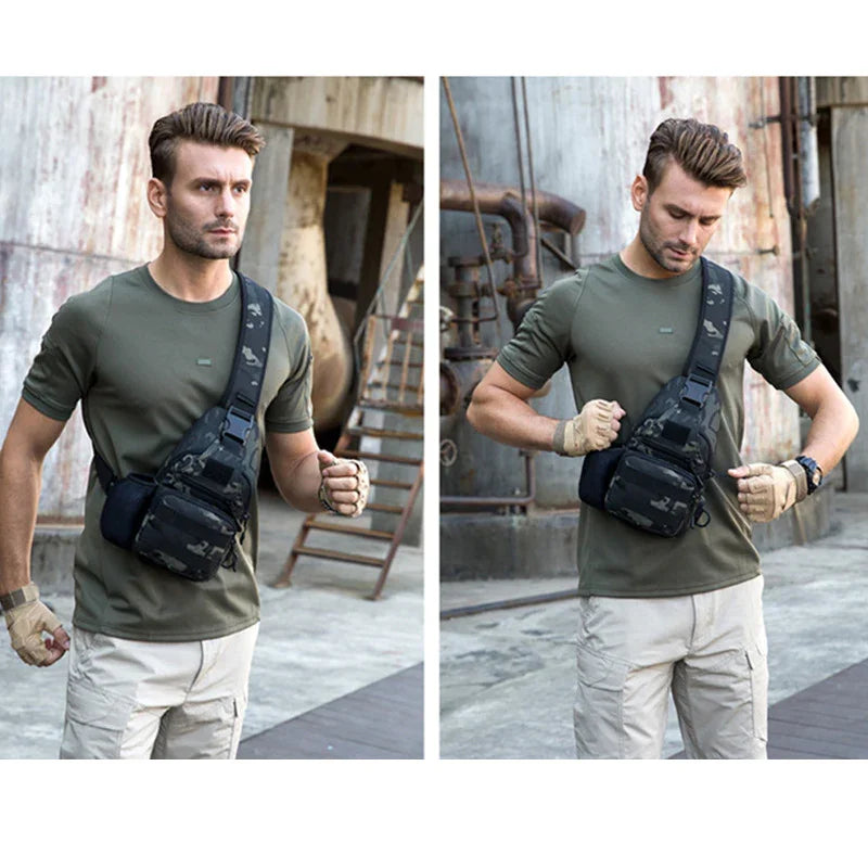 Man wearing green tactical shirt, beige pants, and black camouflage sling bag in industrial outdoor setting