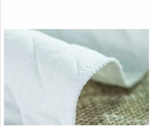Close-up of soft white fabric edge with detailed stitching on woven surface