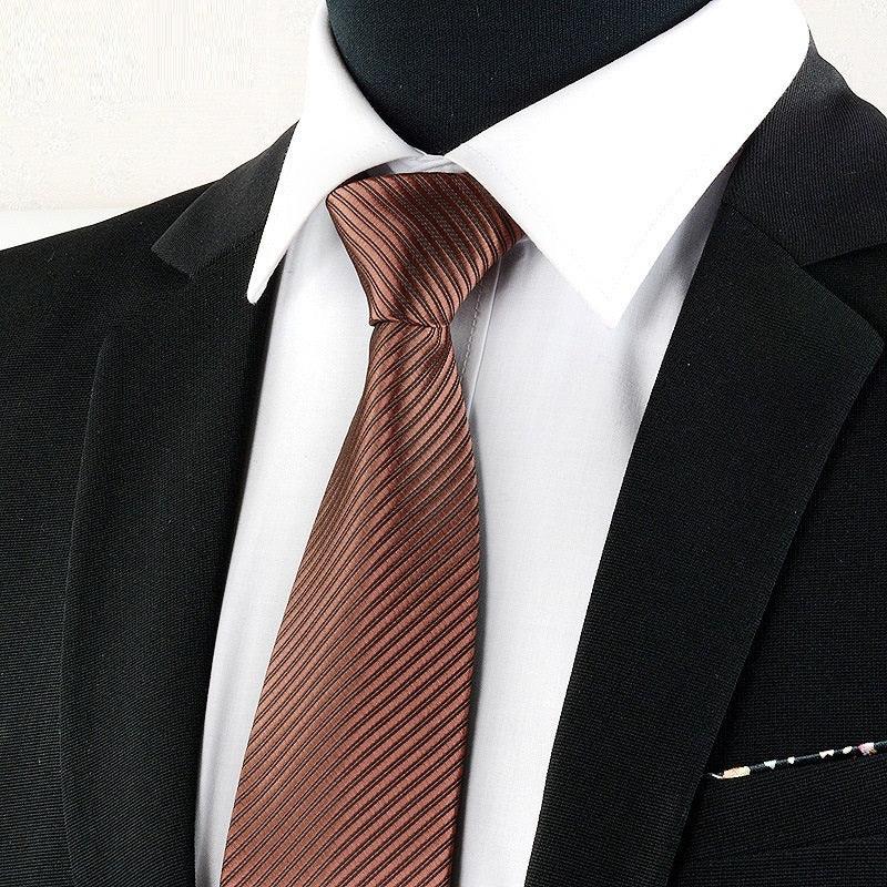 Black suit jacket with white dress shirt and shiny brown striped necktie close-up