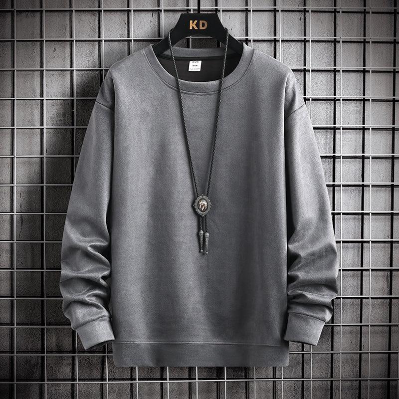 Gray long-sleeve crewneck sweatshirt on black hanger with pendant necklace against metal grid background