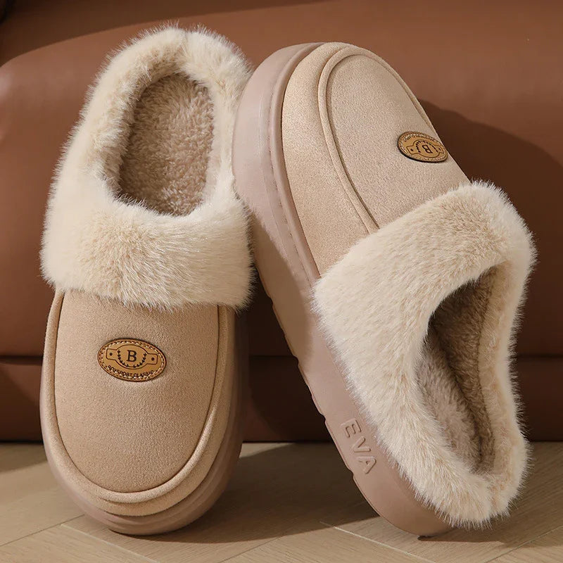 Beige fuzzy winter slippers with plush lining and EVA sole on wooden floor