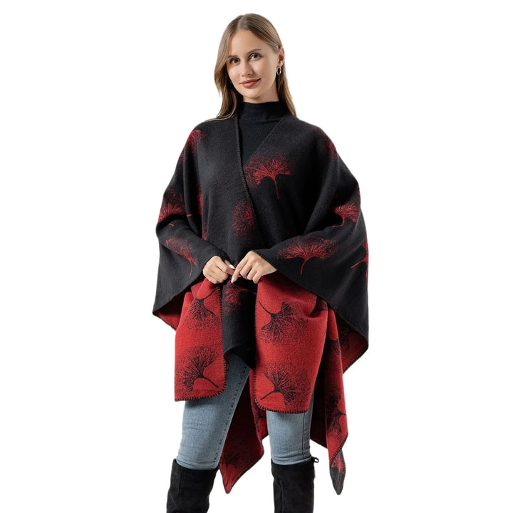 Woman wearing black and red floral wrap shawl, black turtleneck, jeans, and black boots