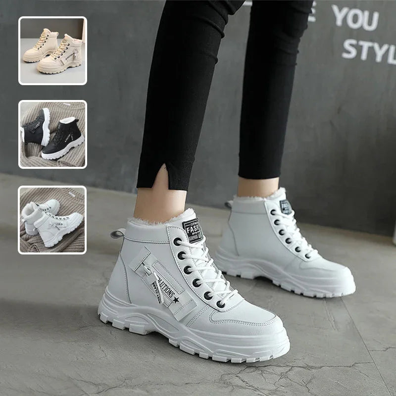 White high-top sneakers with zippers and laces worn with black pants on concrete floor