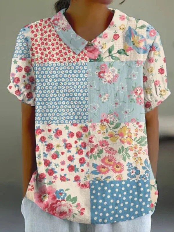Woman wearing a short-sleeve patchwork blouse with floral and polka dot patterns in pastel colors