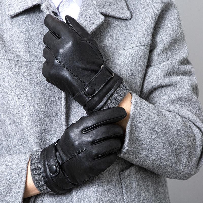 Person wearing black leather gloves and a gray wool coat in a close-up fashion shot