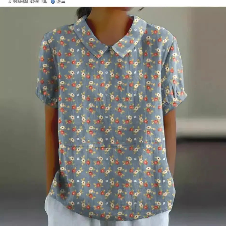 Woman wearing blue floral short-sleeve blouse with Peter Pan collar and white pants