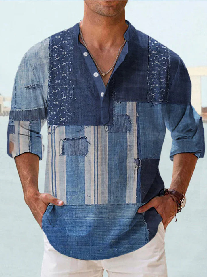 Man wearing a patchwork denim-style long-sleeve henley shirt with rolled sleeves and white pants