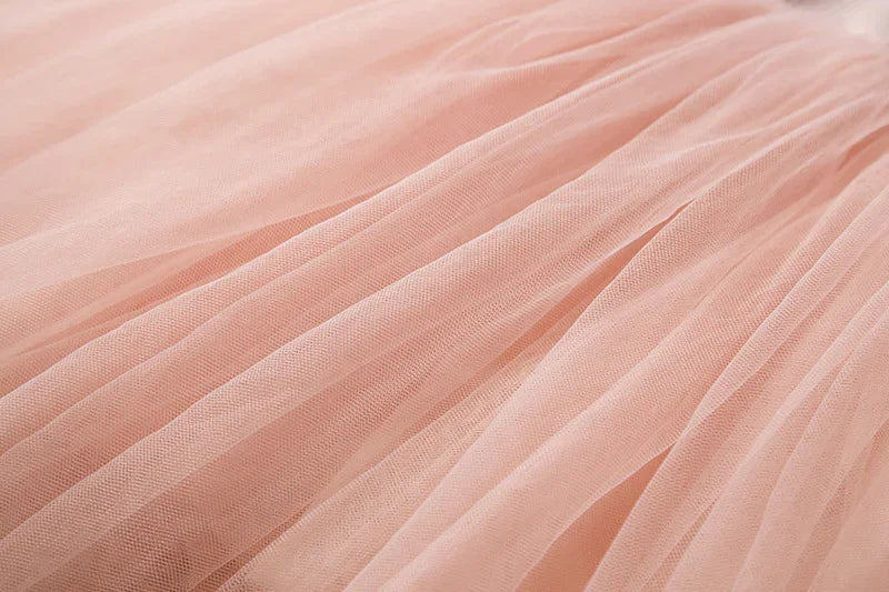 Close-up of soft pink tulle fabric with fine mesh texture and delicate folds